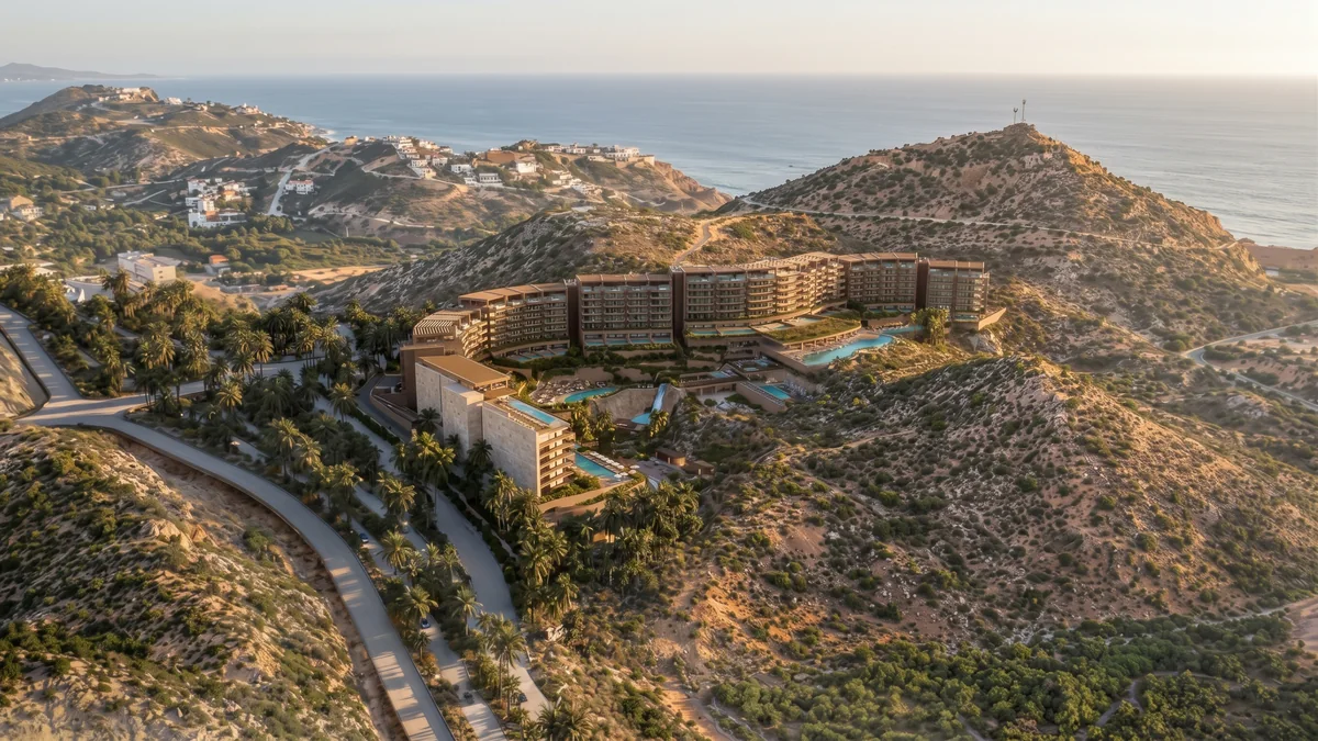 Render of DUNNA&rsquo;s residences and pools set into the Baja hills, with the ocean beyond